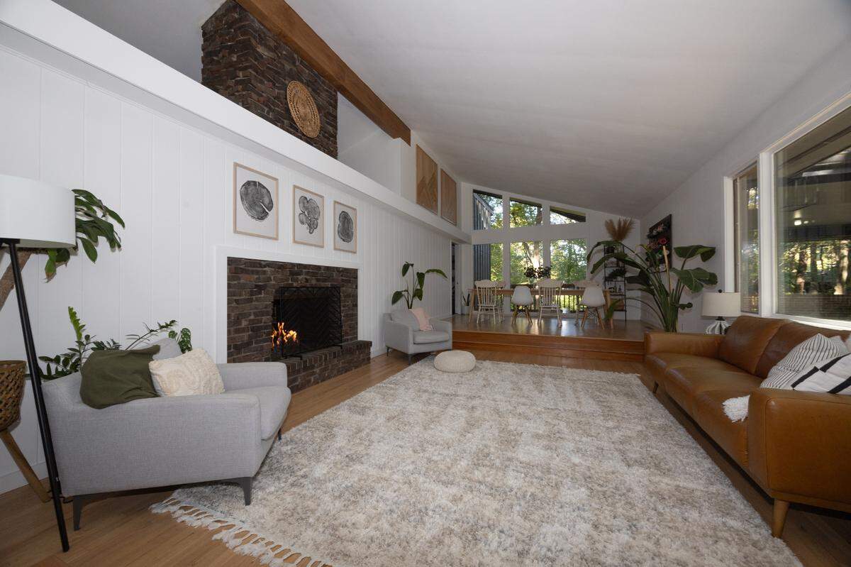 Inside the home of Mitchell and Candice Jackson along Brook Hill Point in Belleville. The floor to ceiling windows and large stone fireplace are highly characteristic for houses of the same style.