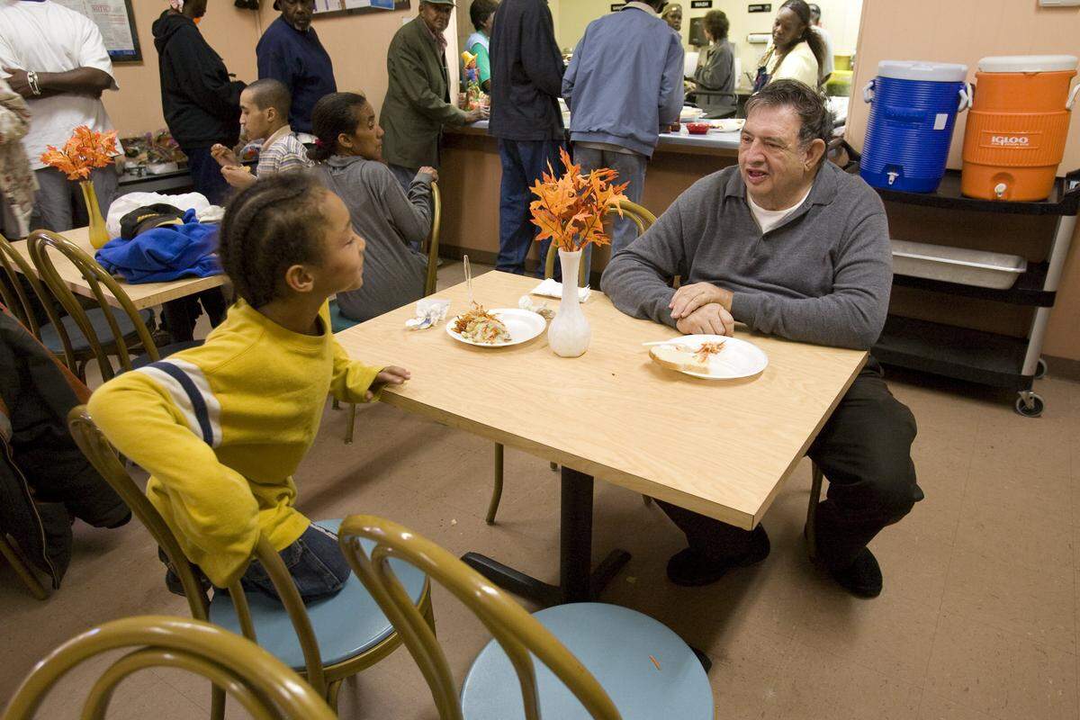 Six-year-old Ernesto Rodriguez, of Washington Park, stops to chat with Joe Hubbard during lunch at Cosgrove's Soup Kitchen in East St. Louis in this file photo.