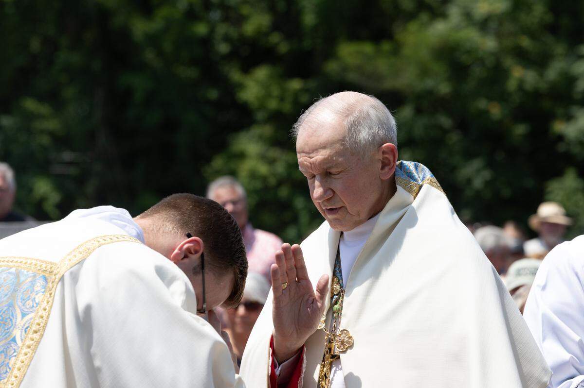 Bishop Thomas John Paprocki blesses a ceremony during a procession from St. Peter’s and Paul’s Catholic Church to a nearby cemetery of the same name in Collinsville, Ill. on July 8, 2024. The procession is part of a nationwide eucharist pilgrimage, with Catholics traveling from San Francisco to the endpoint of the pilgrimage, Indianapolis, picking up fellow pilgrims along the way.