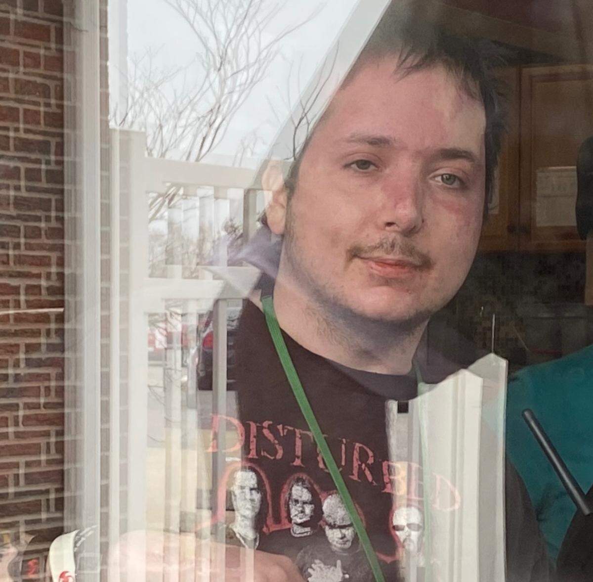 Lynn Ray, Jr. looks out the window from Clinton Manor Living Center in New Baden at his mother Carrie Leljedal, who stands outside to see him while visitor restrictions are in place during the coronavirus pandemic.