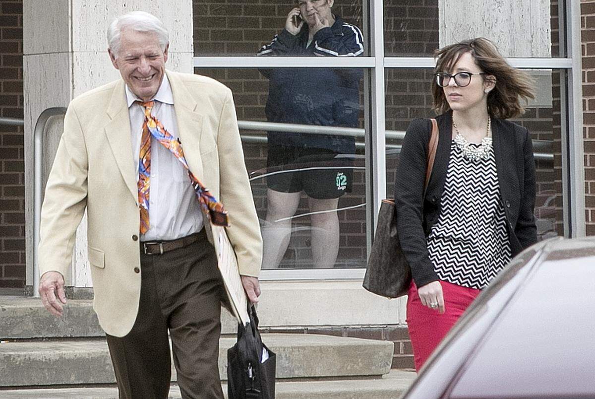 Madison County Public Defender John Rekowski exits Madison County Criminal Justice Center with former assistant Kelcie Miller on April 11, 2019, after a hearing on the Zachary Capers murder case.