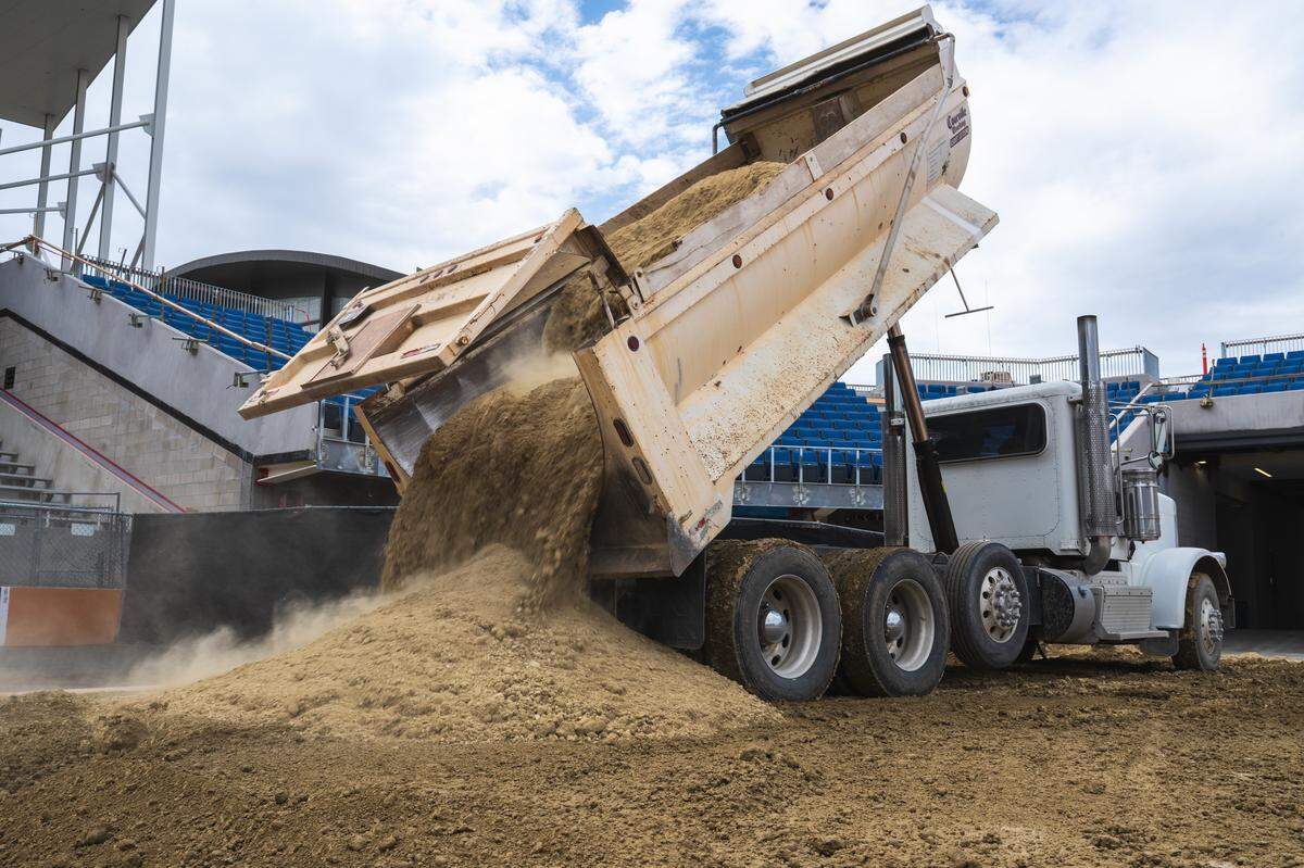 A dump truck pours a fresh new layer of dirt atop the turf at Albertson Stadium in Boise on Wednesday, in preparation for Saturday’s Hot Wheels Monster Trucks Live show.