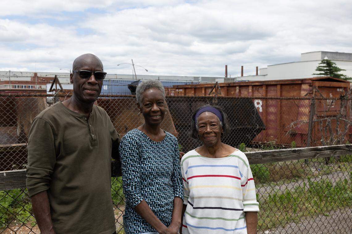Calving Ratliff stands with his sisters Patricia and Dianne in the backyard of their Venice, Ill., home on June 10, 2024.