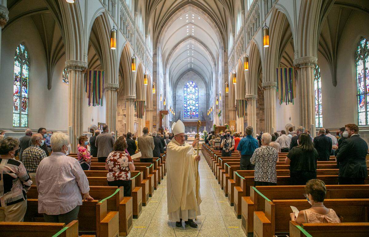 Bishop Michael G. McGovern walks through the Cathedral of St. Peter in Belleville on Wednesday, blessing those who attended his Mass of ordination and installation as the ninth bishop of the Catholic Diocese of Belleville.