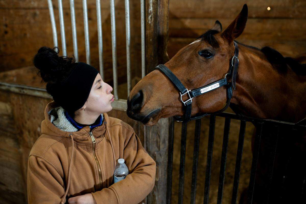 Monica Cazares, 20, of Collinsville, blows a kiss to a horse on Thursday, March 6, 2025, at Fairmount Park in Collinsville.