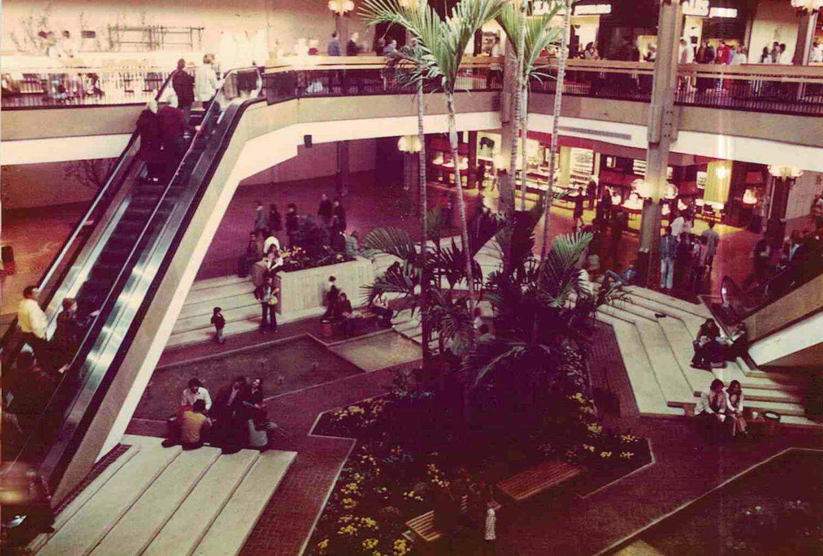 View of the St. Clair Square mall center court with fountains and plants. Courtesy of St. Clair Square