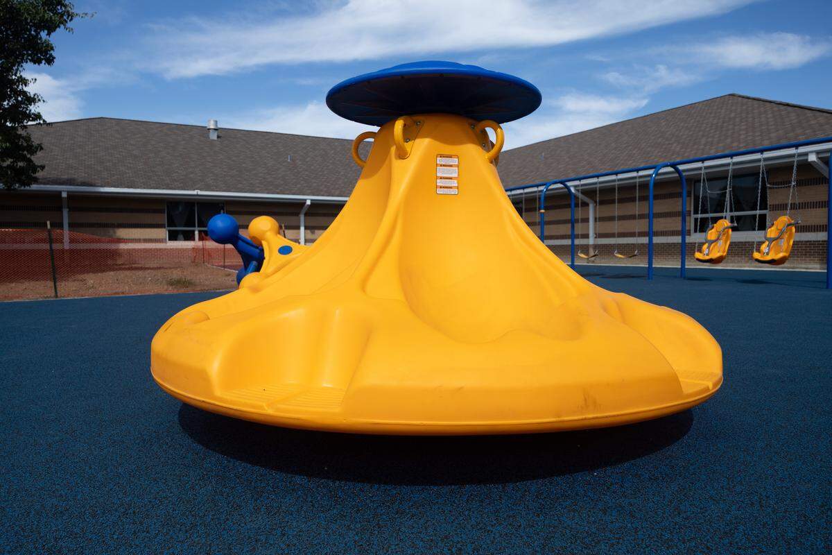 An inclusive spinner, similar to a merry-go-round, provides a fun spinning activity for children of all abilities.
