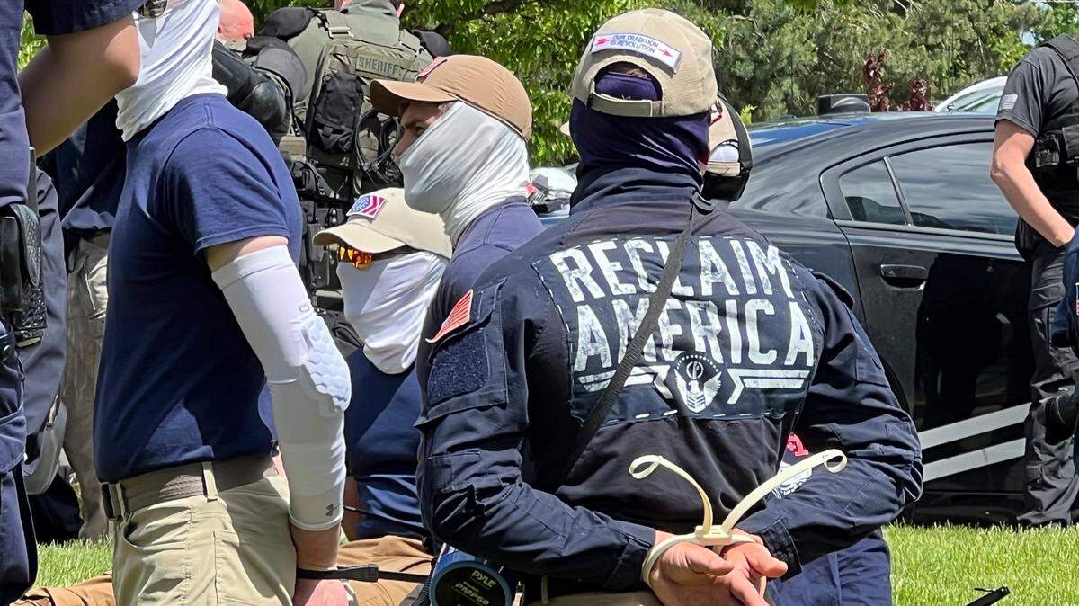 Authorities arrest members of the white supremacist group Patriot Front near an Idaho pride event Saturday, June 11, 2022, after they were found packed into the back of a U-Haul truck with riot gear. (Georji Brown via AP)