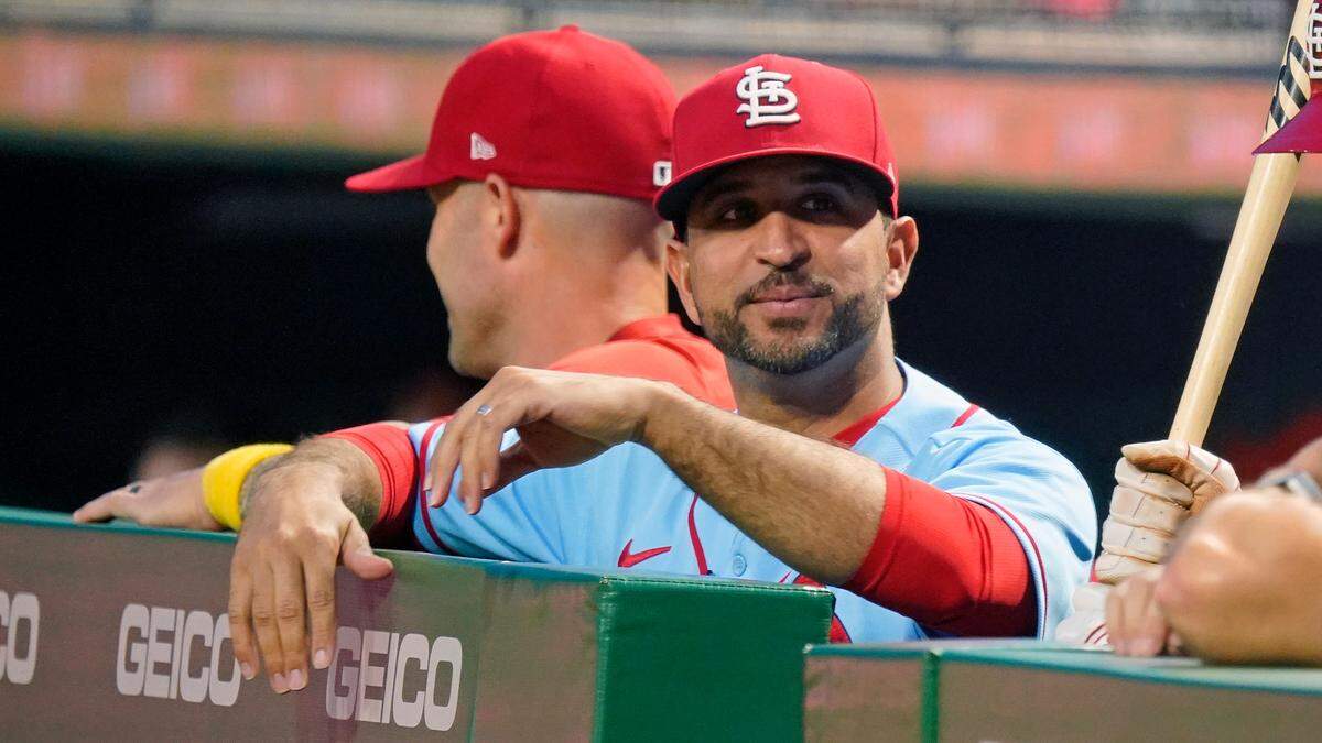 St. Louis Cardinals manager Oliver Marmol, center, stands in the dugout during a game against the Pittsburgh Pirates on Sept. 10. With the Cardinals playoff pole position already locked in, Marmol will try to balance keeping players sharp and getting rest while not losing the edge of winning.