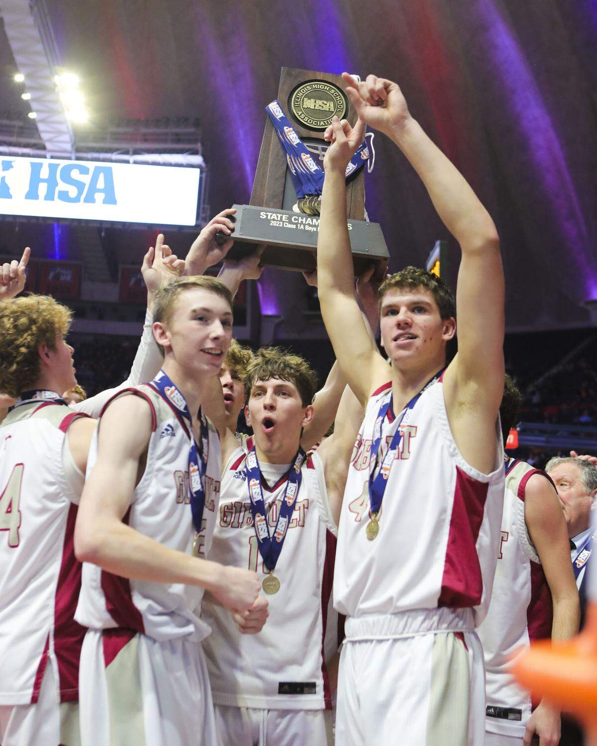 Gibault Catholic’s Kameron Hanvey raises the trophy after Saturday’s IHSA Class 1A state championship game against Scales Mound at State Farm Center on the campus of the University of Illinois. Gibault ultimately prevailed 65-45 to claim the state title.