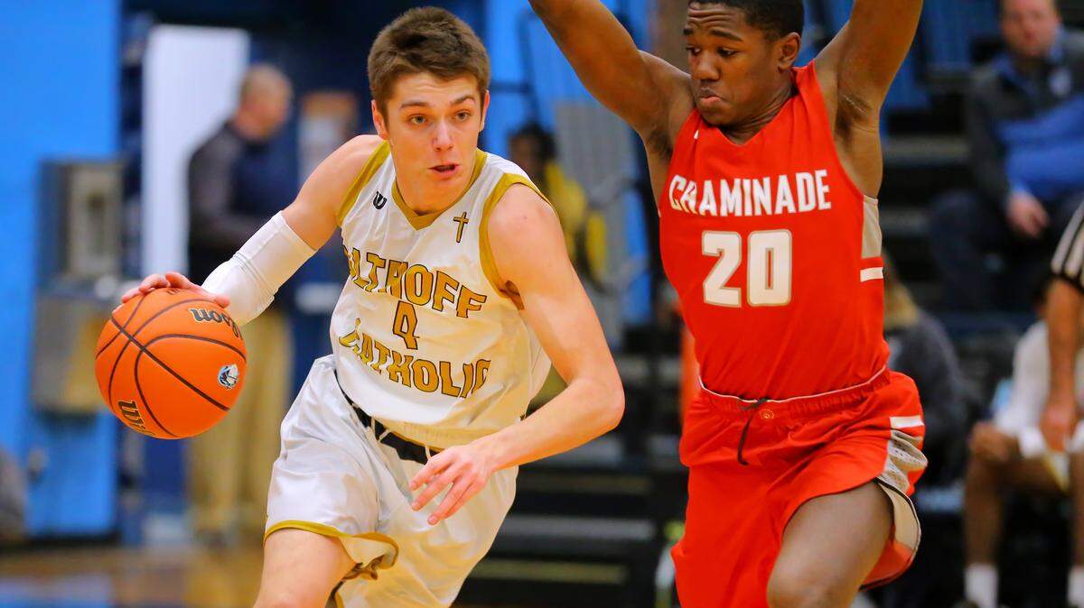 Althoff Daulton Burgner drives against Chaminade Damien Mayo during Wednesday’s Click-fil-A Classic basketball tournament at Belleville East High School.