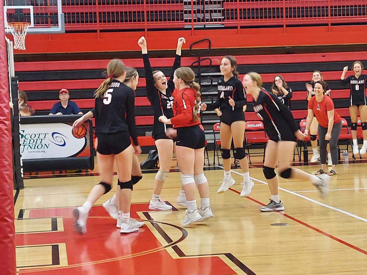 The Highland Lady Bulldogs volleyball team celebrates after beating Collinsville 25-18, 25-18 to win its season-opening match Thursday, Aug. 25, at Highland High School.
