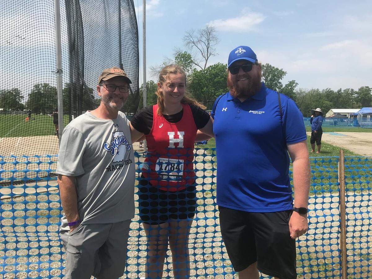 Pictured are 2022 Highland High School graduate and Indiana State freshman-to-be thrower Josie Hapack with HHS volunteer coach Dave Giger and Indiana State throwing coach Brandan Bettenhausen as she celebrates her two medal performance May 21 at the IHSA Class 2A state track meet at Eastern Illinois University in Charleston. Hapack is excited about starting her Sycamore career this fall.