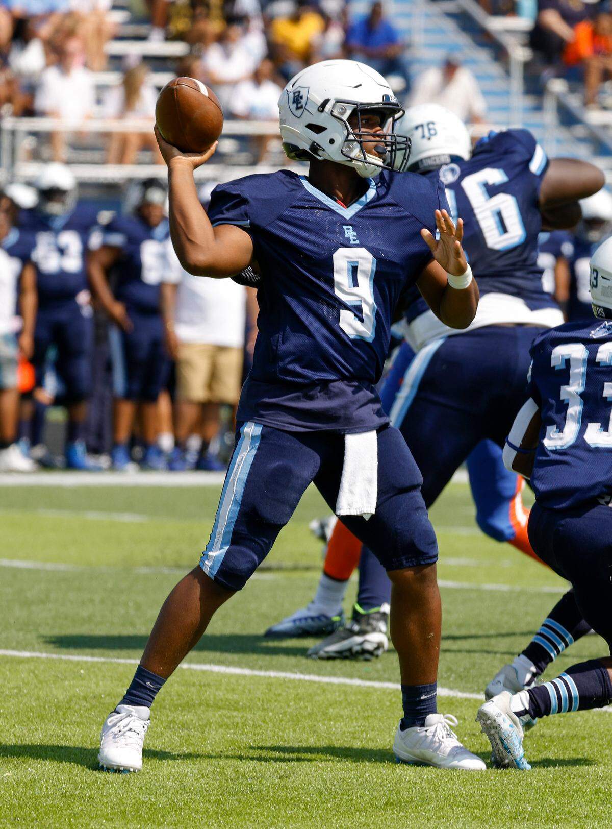 Belleville East quarterback Darron Millender Jr. drops back to pass the ball against visiting East St. Louis during a Southwestern Conference game Saturday. The Lancers and many other metro-east teams are back in action Friday night.