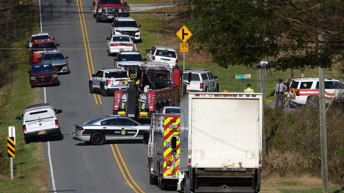 Emergency personnel assemble near the site in Winston-Salem, North Carolina, where a Piper PA-30 Twin Comanche plane crashed Saturday morning, killing a Freeburg couple.