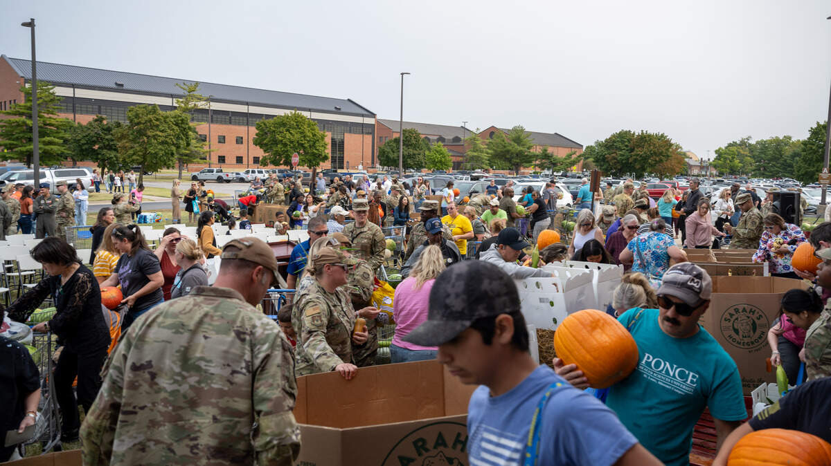 Members of Team Scott gather during a ceremony to launch the Environmental Protection Agency’s new nationwide program to distribute excess food, “Feed it Onward,” on Scott Air Force Base, Illinois, Sept. 5, 2025. Following the ceremony, free excess produce was given out to the Scott Air Force Base community. (U.S. Air Force photo by Senior Airman Violette Hosack)