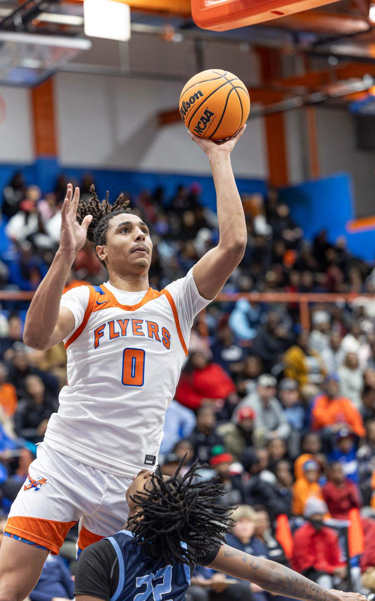 Jamison White goes hard to the basket for two of his 20 points against Belleville East Friday.
