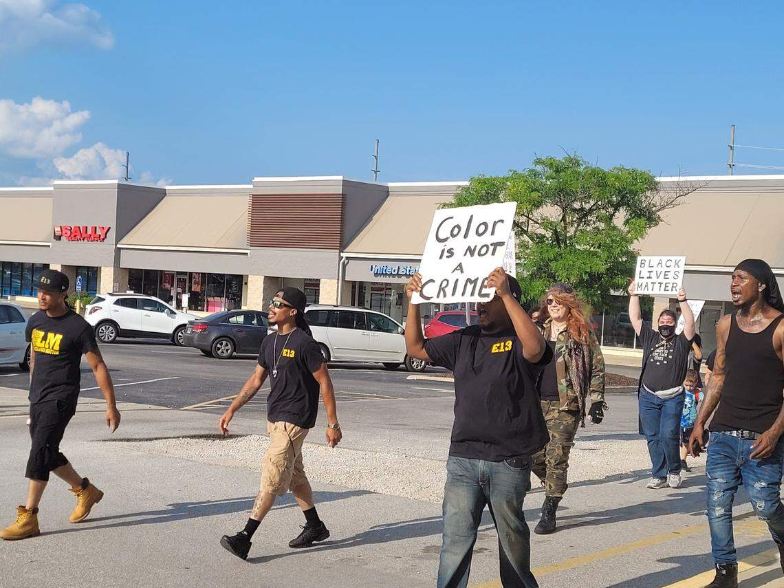 Protesters march near Sky Zone located at 10850 Lincoln Trail in Fairview Heights on Sunday evening