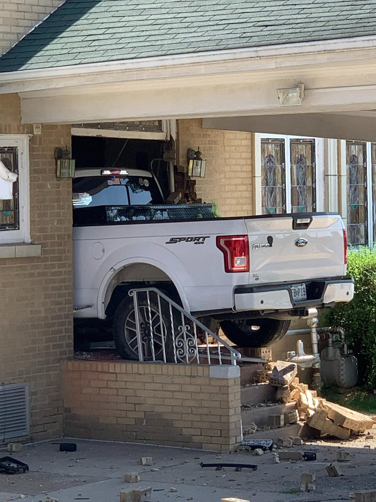 A white Ford truck that crashed into Kassly-Meridith Funeral Home in Collinsville early Sunday was still lodged in the building on Monday.
