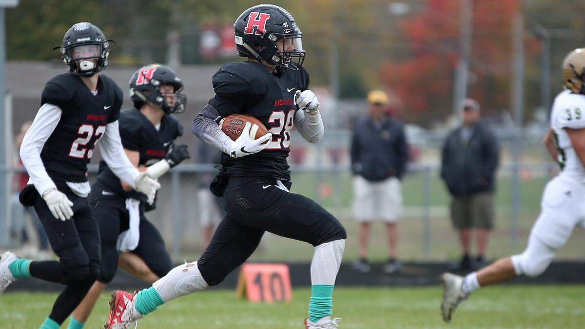 Highland senior Brady Feldmann gets an escort into the end zone during the Bulldogs’ win over Mattoon in the second round of the Class 5A state football playoffs.