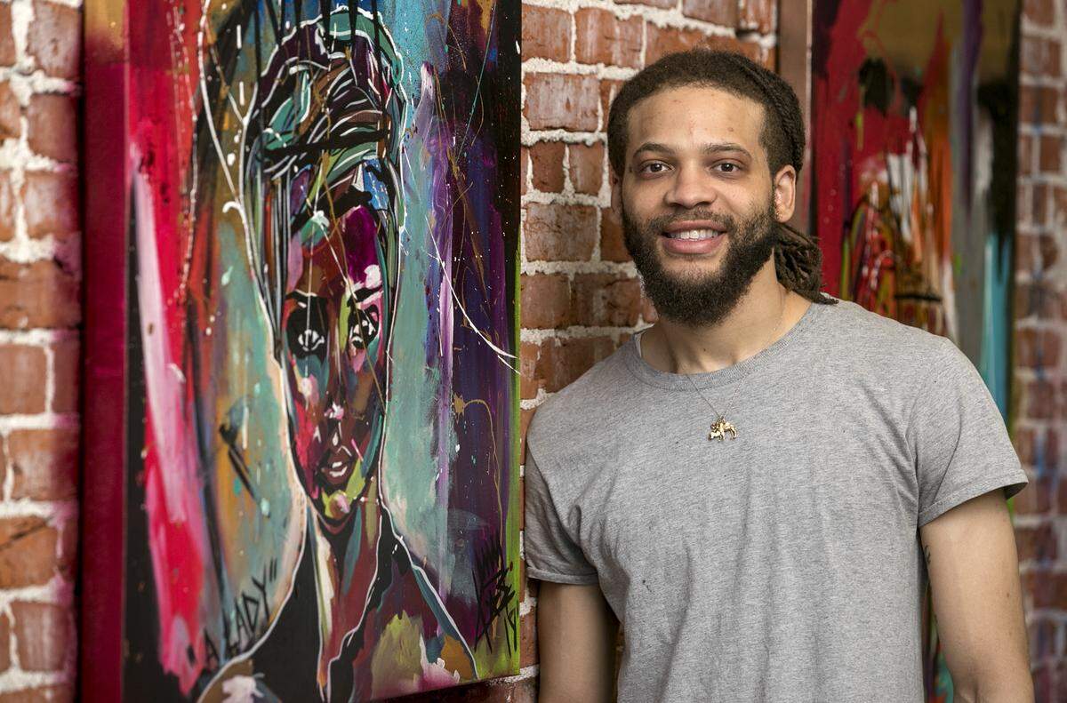 Artist Kas King stands next to his mixed media work titled “A Lady.” King is planing a July 7th show featuring this work and others.