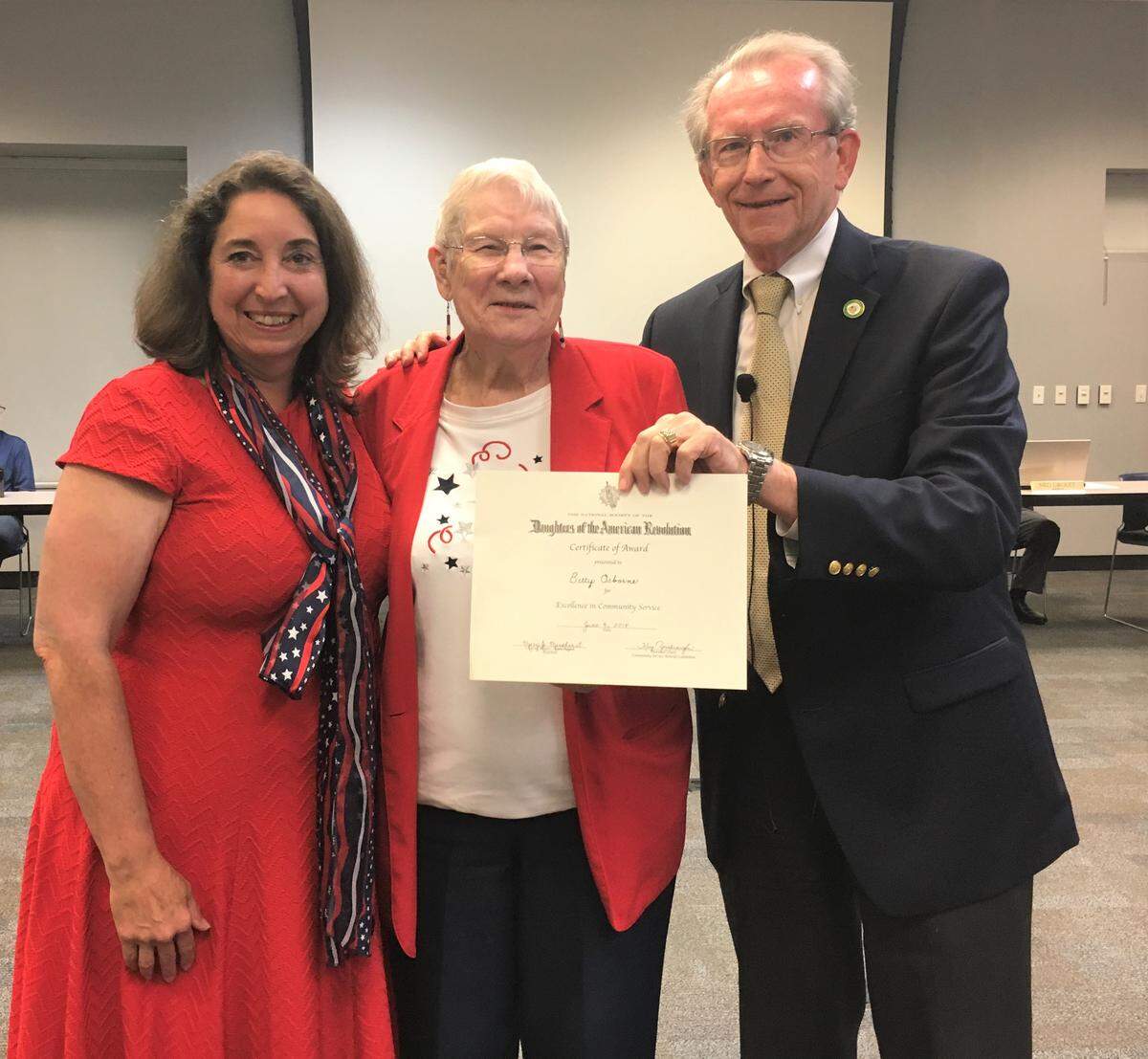 Betty Osborne was honored by the Daughters of the American Revolution before the June 4 O'Fallon City Council meeting June 4. Kathy Dice, left, represented the Cahokia Mounds Chapter. On right is O'Fallon Mayor Herb Roach.