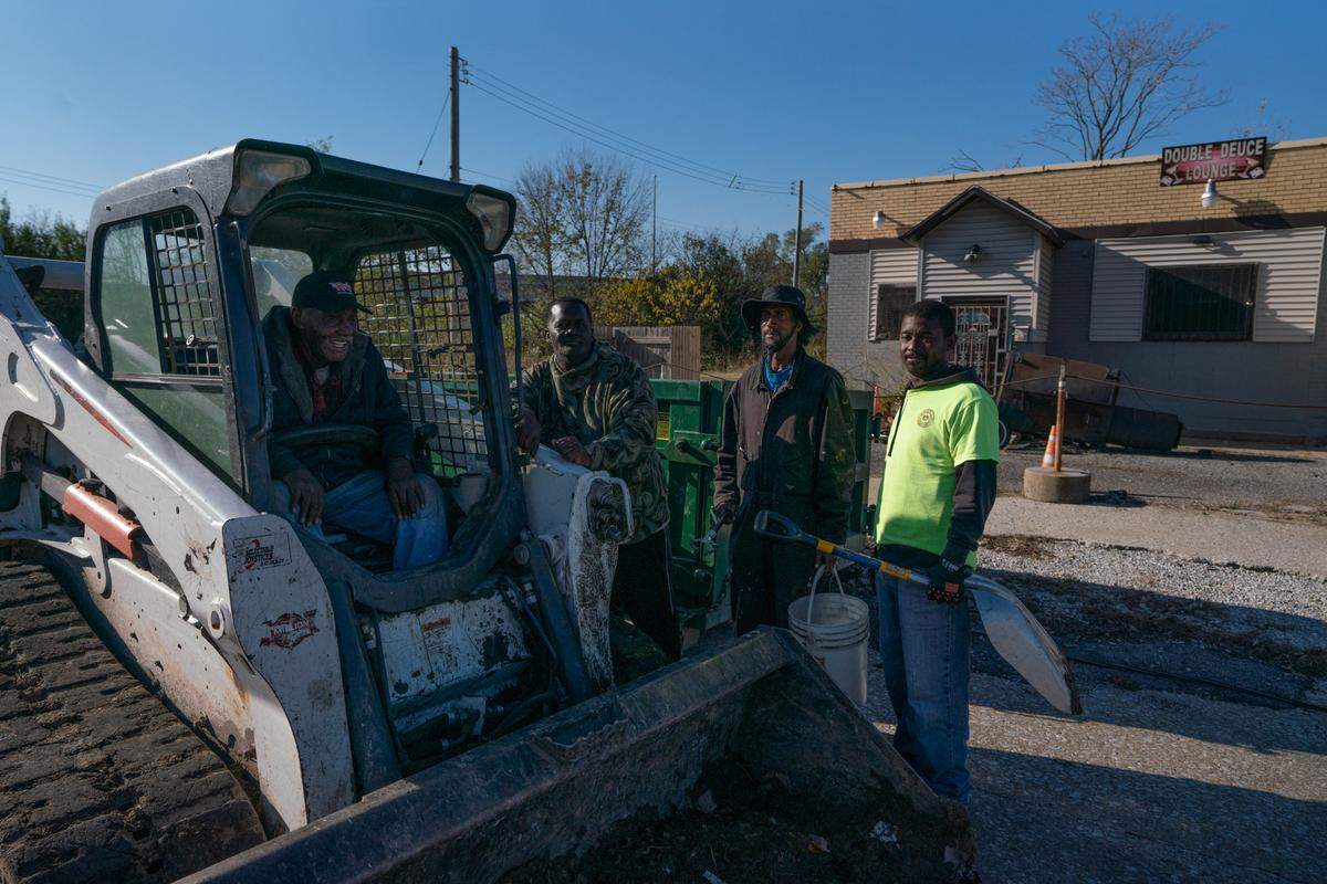 Employees for the city of East St. Louis take a break during a cleanup in East St. Louis on Nov. 15, 2024.