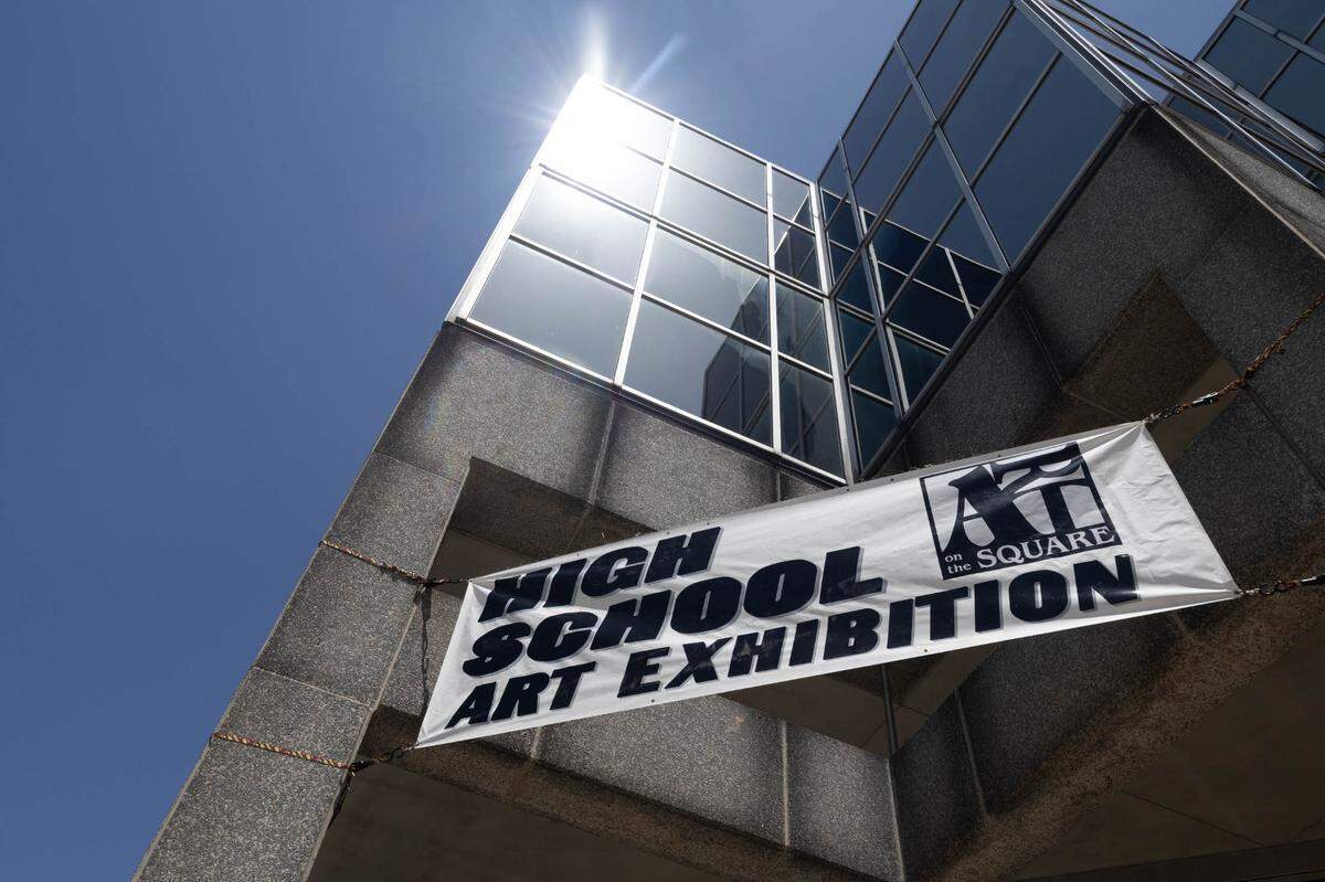 A sign on the Mathis, Marifian and Richter building displaying last year’s high school art exhibition for Art on the Square.