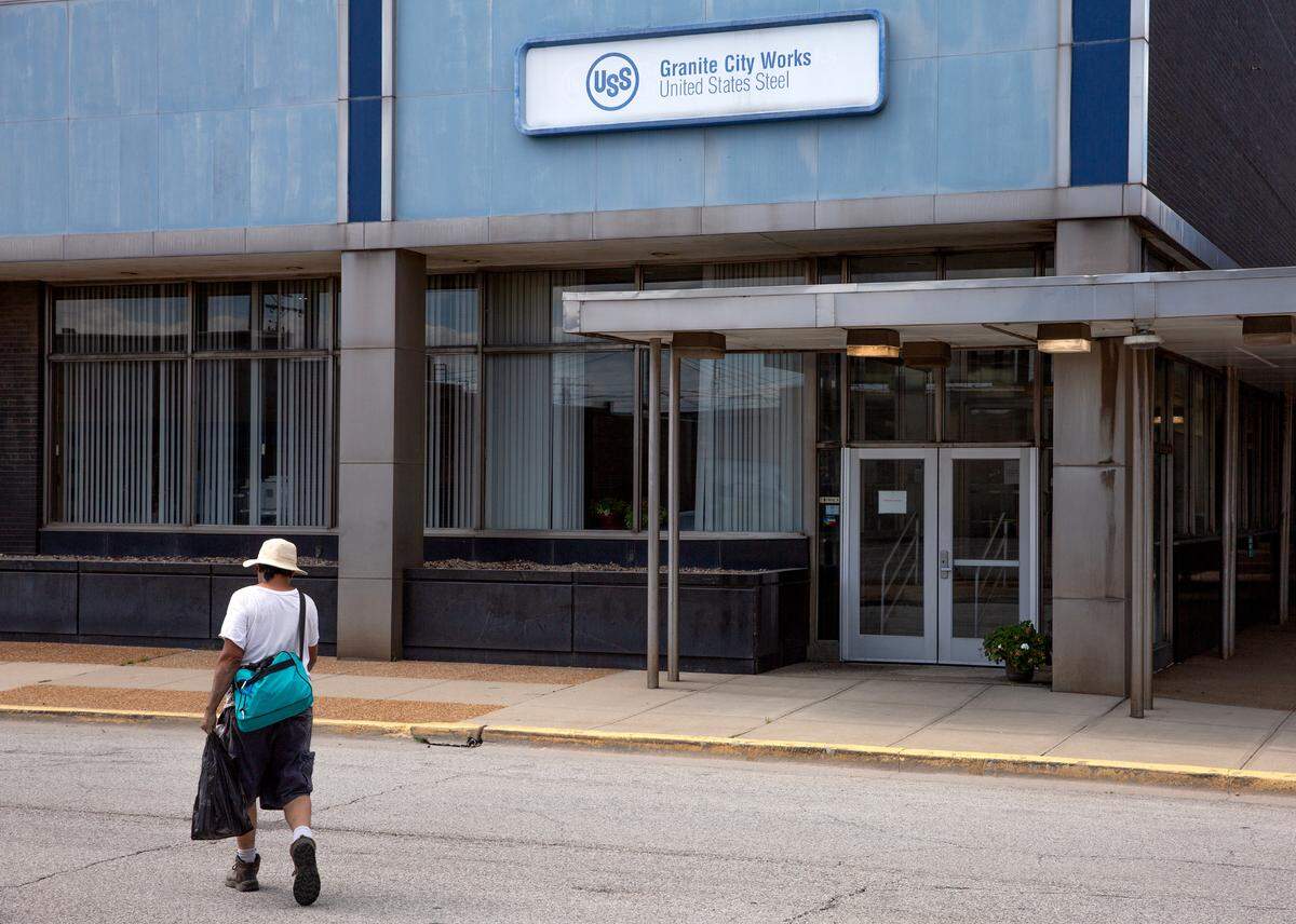 A man walks past the U.S. Steel Granite City Steel Building on Wednesday, Aug. 30, 2023, in Granite City, Ill.