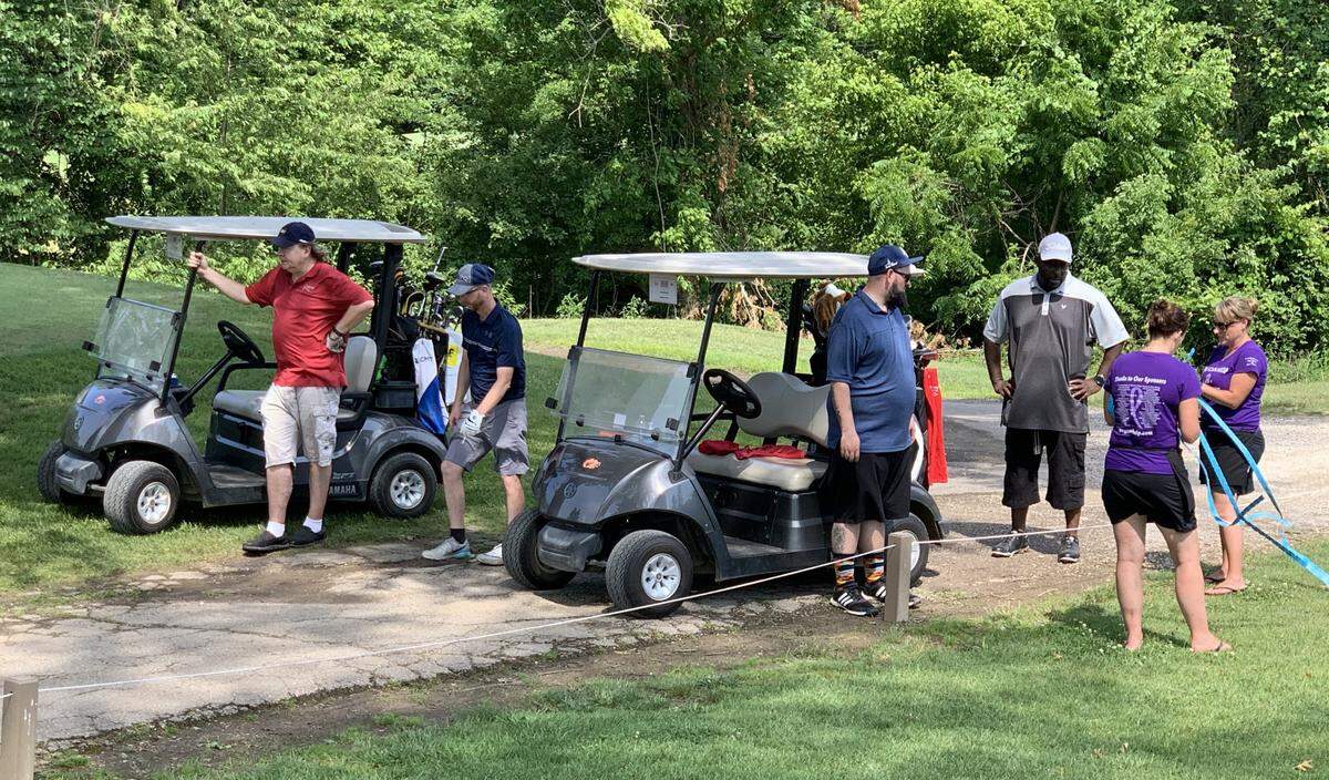 Rachel Budko, far right, assists golfers participating in the PEG Can Help Benefit Golf Scramble, which was held on June 20 at Oak Valley Golf Course & Resort in Pevely, Missouri.