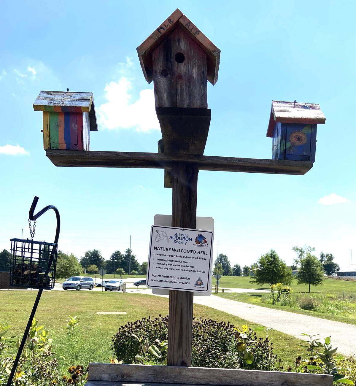 To teach about nature and ecosystem interactions, Life Sciences teacher Mellenthin took the classroom outside at Carriel Junior High School several years ago, planting butterfly and vegetable gardens in a side yard, and later, a pollinator patch of native prairie grasses across the road. Pictured are birdhouses donated by the St. Louis Audubon Society.