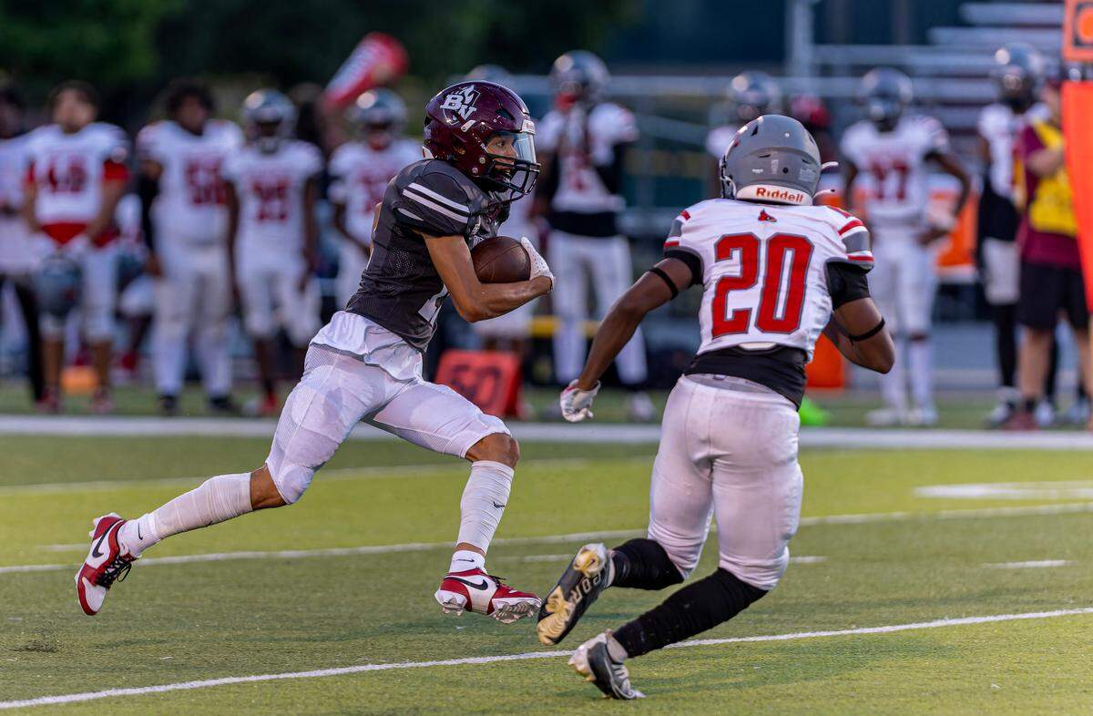 September 20, 2024 - Belleville, IL - Calvin Nolan (11) carries the ball while under pressure during Friday nightsÕs conference matchup between Belleville West and Alton Redbirds on Friday Sept 20, 2024 in Belleville IL. [Photo: Jimmy Simmons]