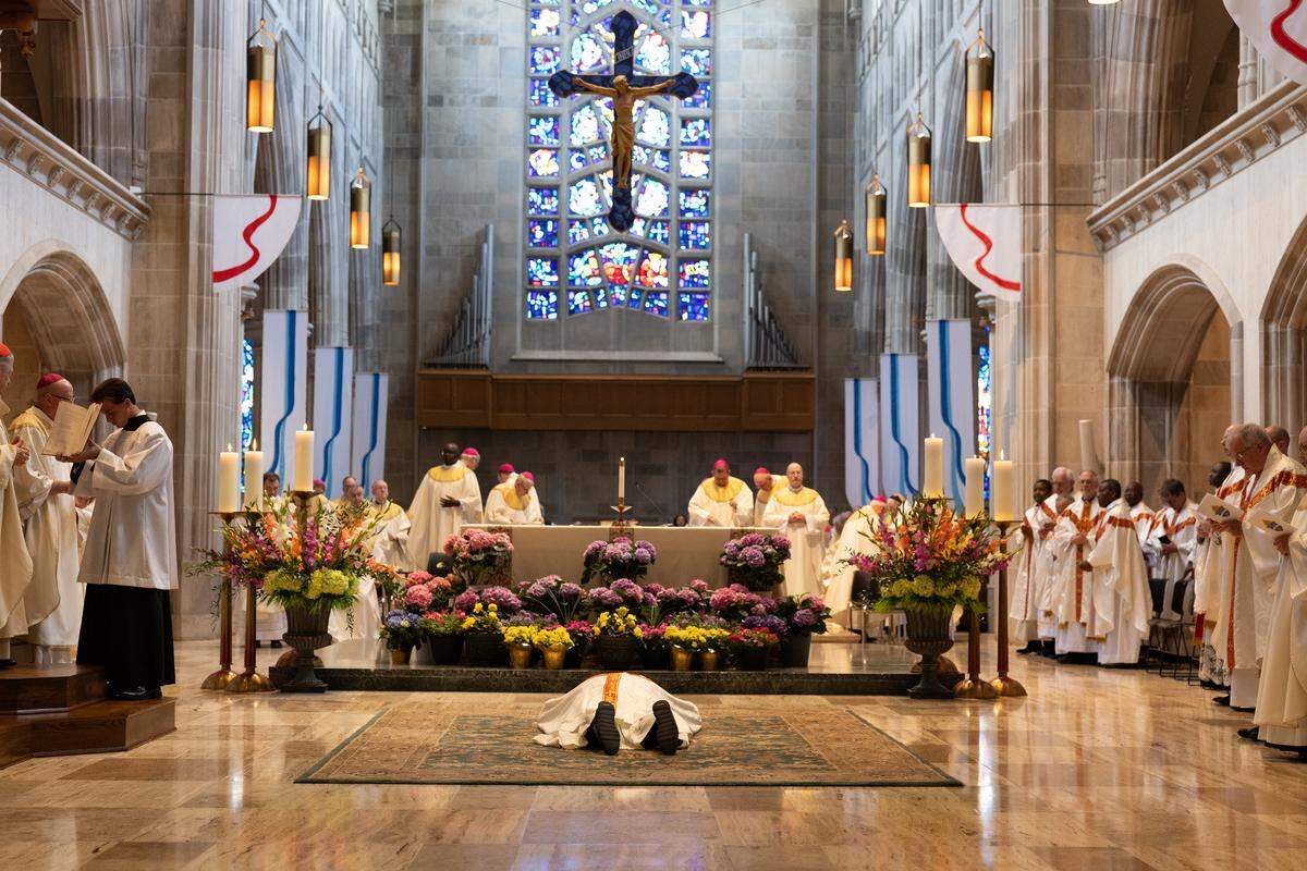 The Rev. Godfrey Mullen lies prostrate in front of the altar at the Cathedral of St. Peter during his installation as bishop of Belleville on Friday.