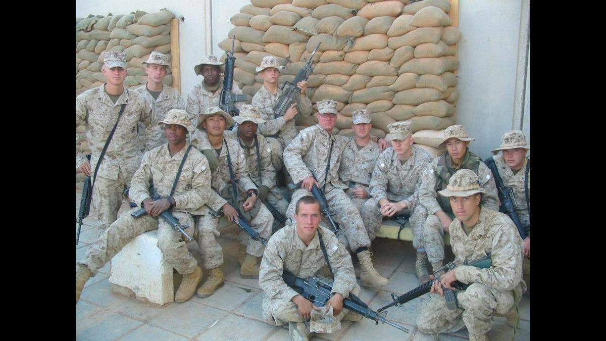 Matthew Wyatt (center) sits on the lap of Sgt. Greg Iworsky in Trebil, Iraq, sometime in September 2004. Second from the right is Cpl. Binh Le, who, along with Matt, died in the bombing on Dec. 3, 2004.