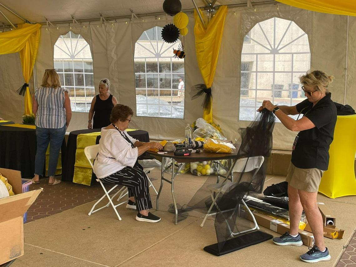 Carol Bartle, co-director of Belleville’s Art on the Square, works with her team to set up the for the 21st annual fine arts show. The show begins Friday afternoon and runs through Sunday around Public Square in Belleville