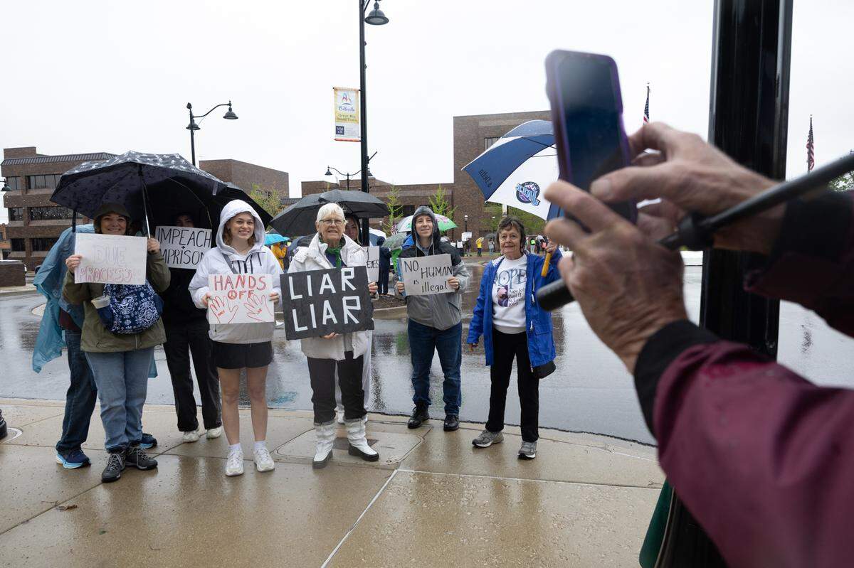 Members of the Southwestern Illinois Democratic Women pose for a photo during a protest at the Belleville Public Square.