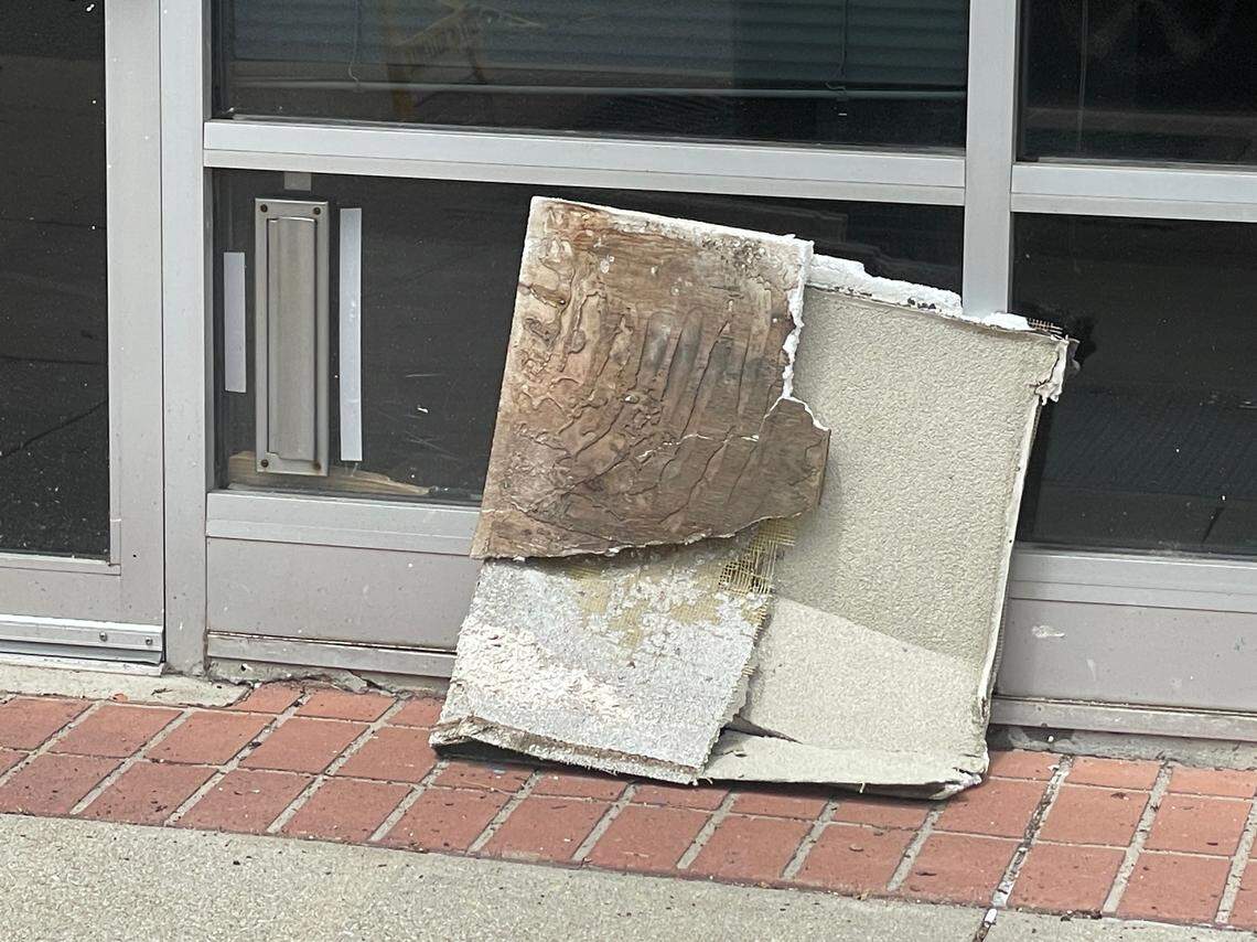 A section of the decorative roof overhang at the Market Square Building was on the sidewalk Monday along East Main Street. The city has blocked off the sidewalk in front of the building.