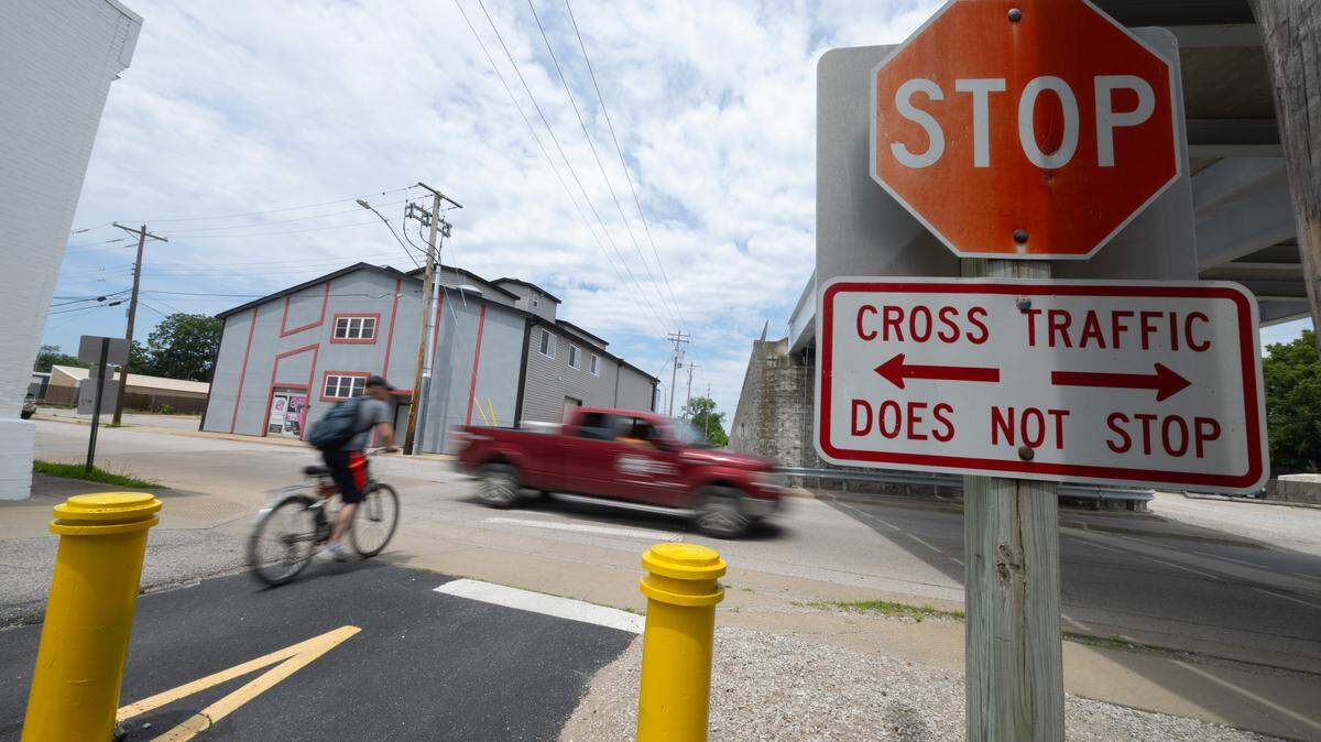 A bicyclist enters East B Street from a bike trail in Belleville this summer. A new plan will help guide decision-making on further trail development. 