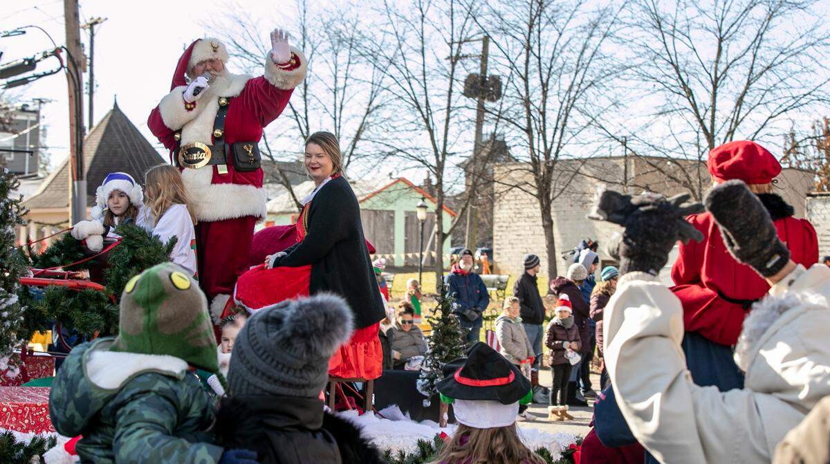 Santa Claus waves to the crowd lining East Main Street in downtown Belleville during last year’s annual Santa parade, sponsored by the Optimist Club of Belleville. The parade has been held since 1952 and features floats, marching bands, dance groups and the arrival of Santa.