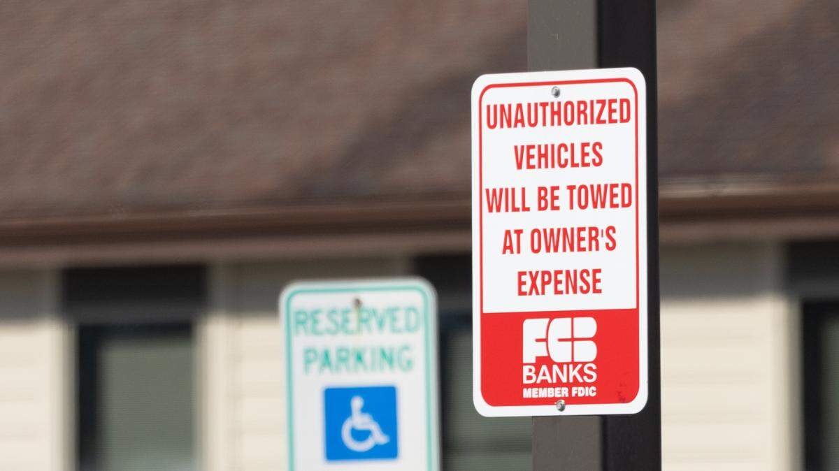 A tow away sign at FC Bank in Belleville, Ill., is seen Jan. 15, 2025. Here’s what to know about state law and local ordinances regulating the towing of vehicles.