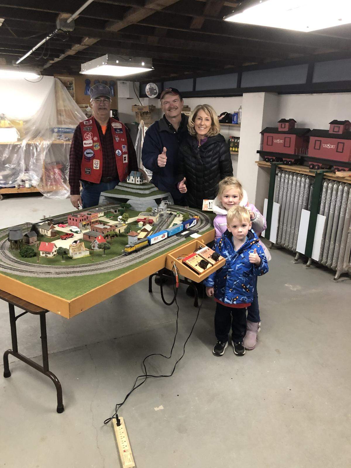 The winner of the New Switzerland Model Railroad layout for 2022 is Steve Saxby. From left, Dale Mollet New Switzerland Model Railroad Club president, and Steve and Cindy Saxby with their grandchildren, Charlotte, and Alexander.