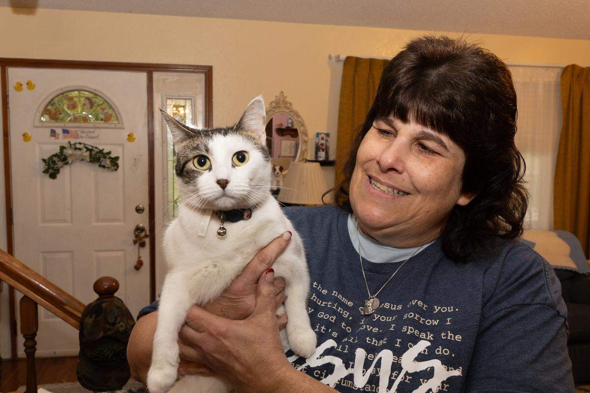 Toni Link holds up Naomi, a cat that her Pontoon Beach family adopted shortly after the suicide of her youngest child, Naomi Link, in 2024.