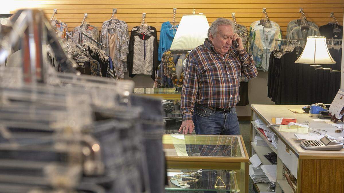 Roger Wigginton, president of Don Rodgers Ltd. in Belleville, talks to a customer by phone last spring, when “non-essential” businesses such as his clothing store were closed due to the COVID-19 shutdown.