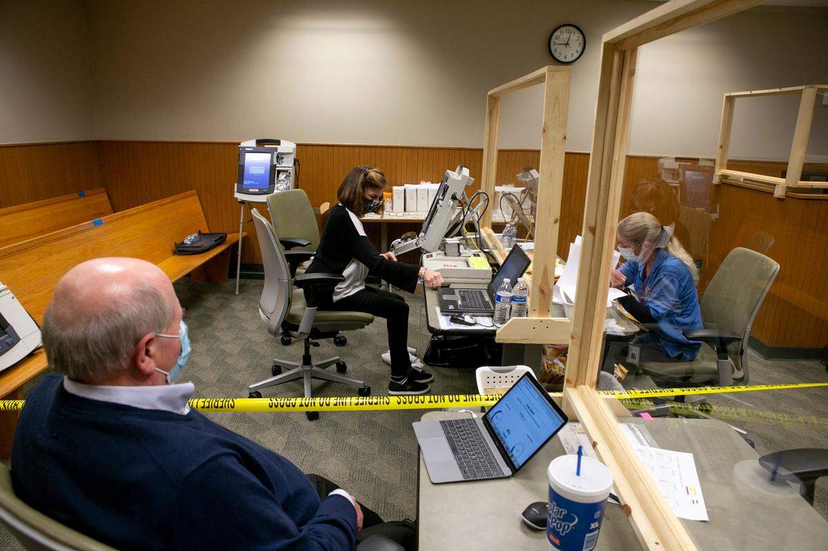 St. Clair County Clerk Tom Holbrook watches as county clerk employees tabulate votes from each precinct.