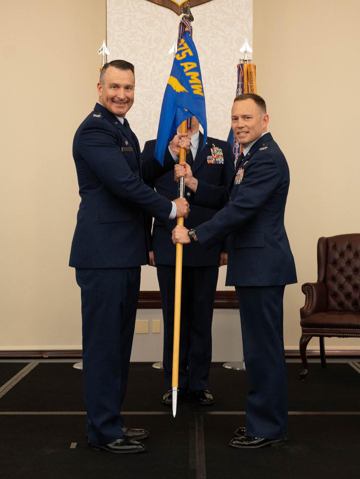 U.S. Air Force Col. Raymond Clydesdale, 375th Medical Group commander, assumes command of the 375th MDG after receiving the guidon from Col. Chris Robinson, 375th Air Mobility Wing commander, on Scott Air Force Base, June 23. As a chief flight surgeon, Clydesdale has flown 775 hours in 15 different aircraft.