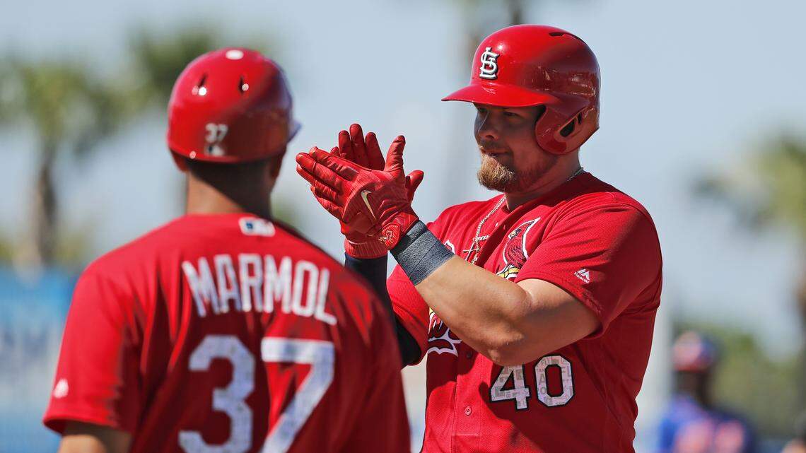St. Louis Cardinals’ Luke Voit (40) applauds after hitting an RBI single as first base coach Oliver Marmol (37) watches during the third inning of a spring training game against the New York Mets on Saturday, Feb. 24, 2018. The minor league slugger was traded to the Yankees Saturday for a pair of relief pitchers.