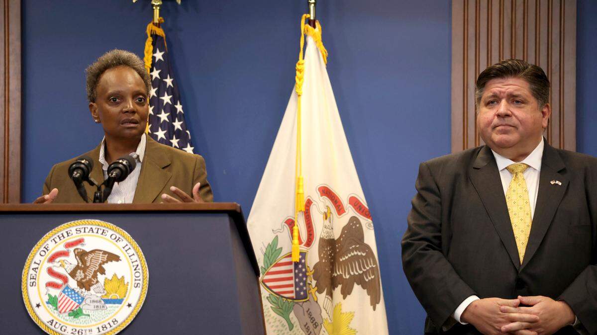 Mayor Lori Lightfoot provides an update on the new migrant arrivals, as Gov. J.B. Pritzker listens in, during a press conference in Chicago, Wednesday, Sept. 14, 2022. (Antonio Perez/Chicago Tribune via AP)