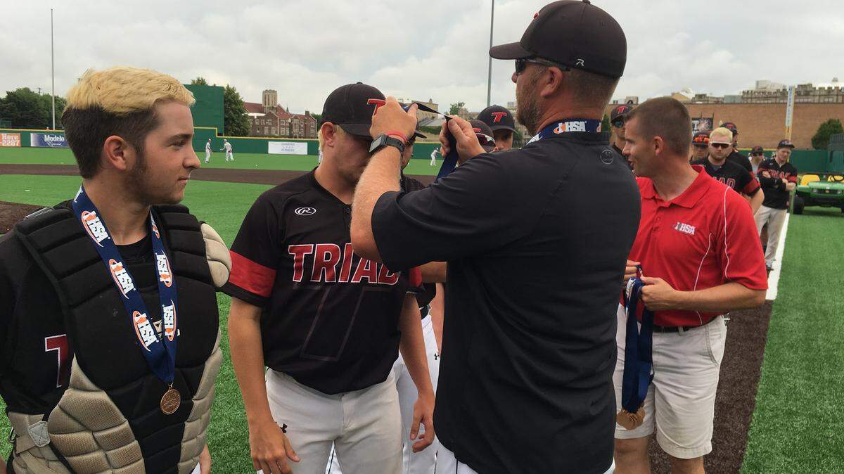 Triad 11-year head coach Jesse Bugger presented his players with their IHSA Class 3A State fourth-place medals at Slammers Stadium in Joliet.