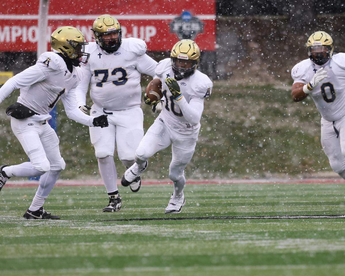 Althoff’s Dierre Hill Jr. carries the ball during the Crusaders’ 57-14 win over Lena-Winslow for the IHSA Class 1A title at Hancock Stadium on the campus of the Illinois State University.