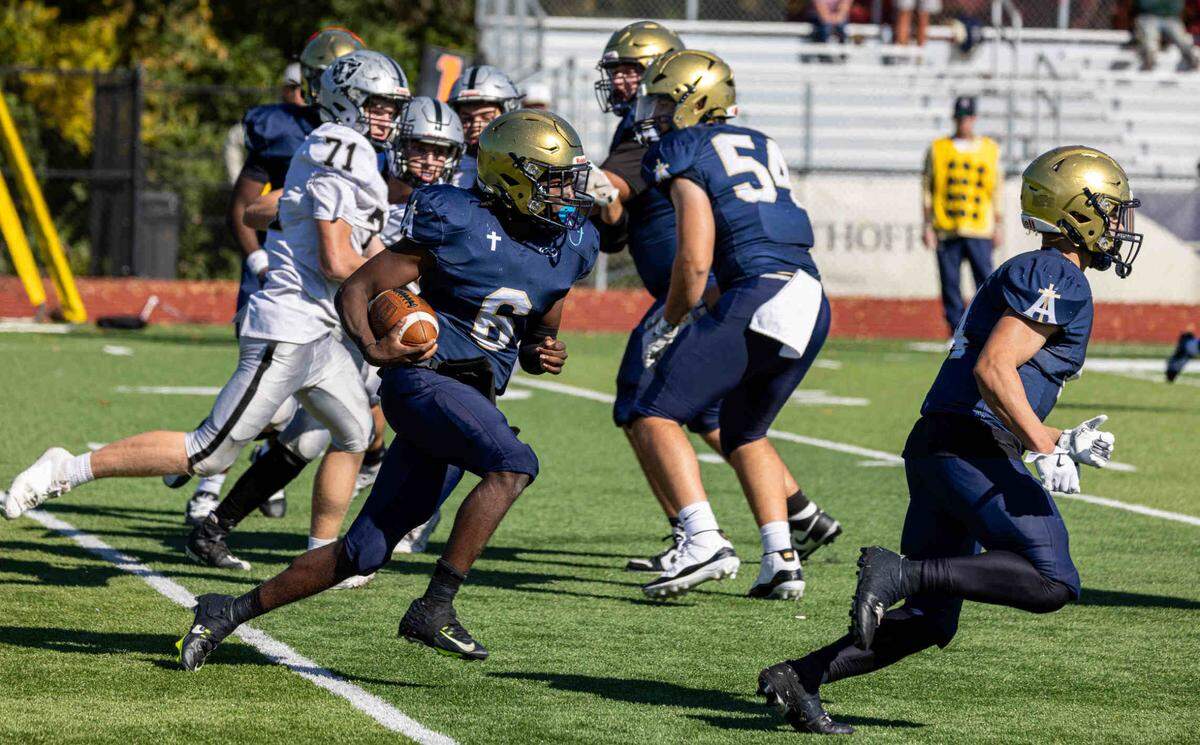 Jayden Ellington (6) carries for Althoff in a game against the Kaneland Knights Saturday.